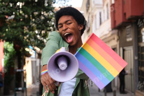 Preview: Young activist shouting with megaphone at lgbt pride parade promoting equal rights