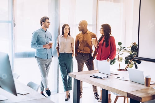 Preview: group of multicultural business people having conversation during coffee break in office