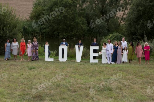 Preview: Wedding guests posing behind love word