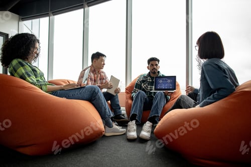 Preview: Designers working with digital car model on laptop in office