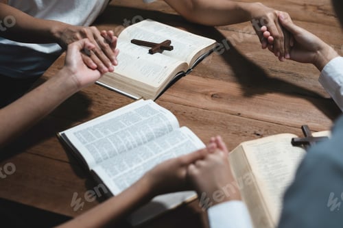 Preview: Asian men and women hands praying to god with the bible.