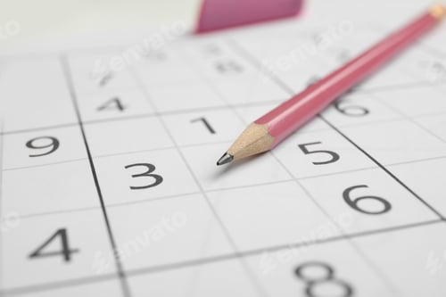 Preview: Sudoku puzzle grid and pencil, closeup view