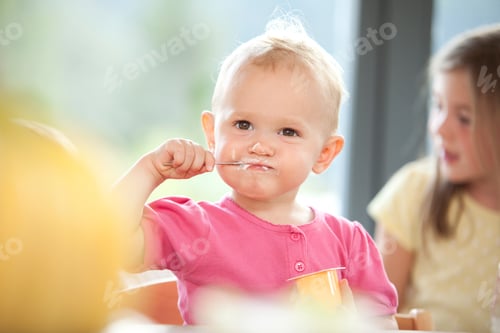 Preview: Baby girl eating yogurt