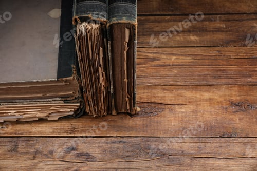 Preview: Many old books on wooden table, closeup. Space for text