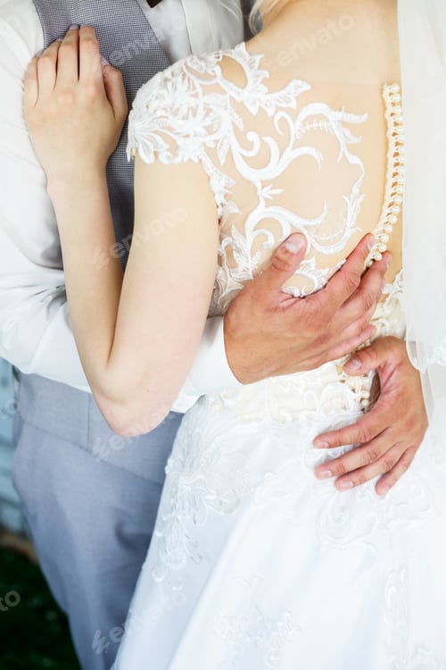 Preview: Bride and groom hugging on a wedding day