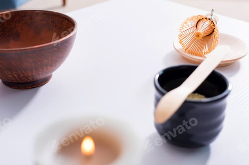 Preview: close up view of arranged ceramic cutlery for tea ceremony on white tabletop