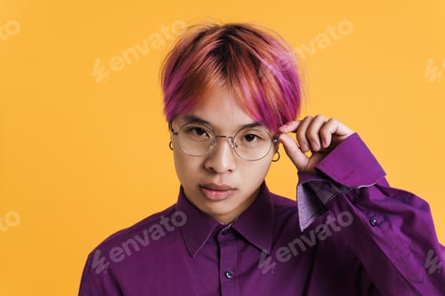 Preview: Asian boy in eyeglasses posing and looking at camera