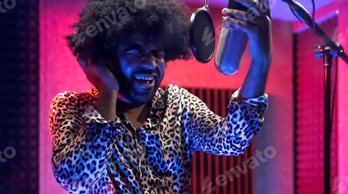 Preview: Young professional afro singer recording a new song album inside music production studio