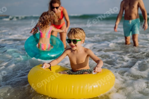 Preview: Happy family with little kids enjoying time at sea in exotic country.