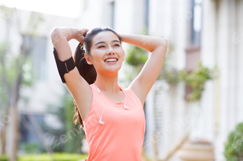 Preview: Happy young woman exercising in the morning