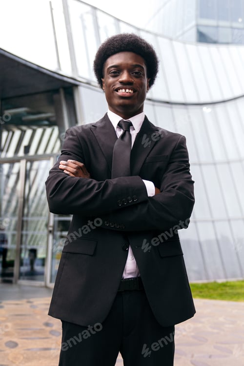 Preview: Self-assured African Entrepreneur in Front of Corporate Glass Building