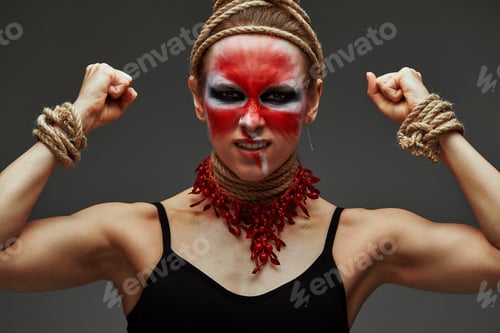 Preview: Portrait of young beautiful girl with colorful face painting with an animal flow move in studio