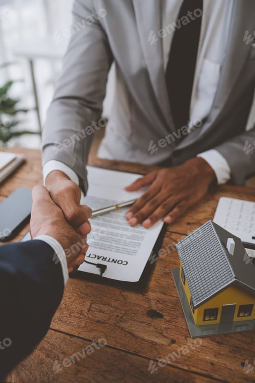 Preview: Real estate broker and client shaking hands after signing sale contract, home loan and congratulatin