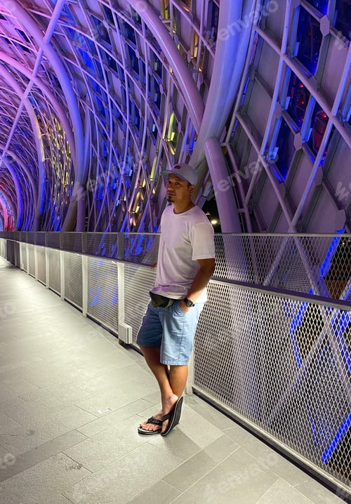 Preview: Man wearing white shirt and hat stand alone.