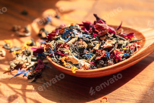 Preview: Handful of natural tea on a wodden surface