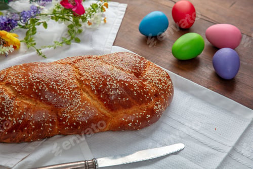 Preview: Easter sweet bread, homemade tsoureki braid and colorful Easter eggs on the table
