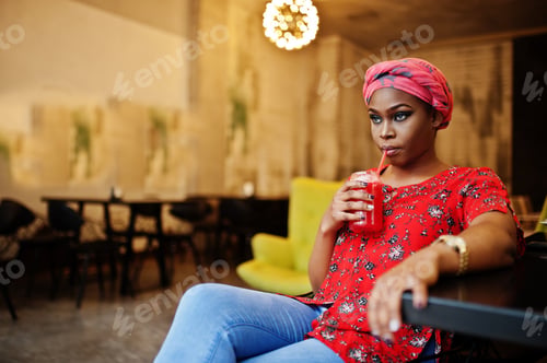 Preview: Stylish african woman in red shirt and hat