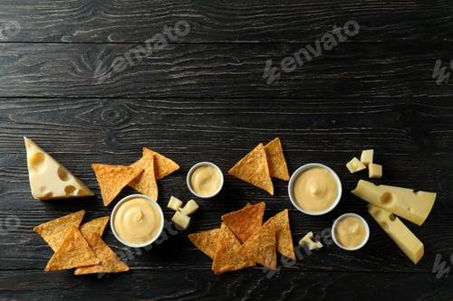 Preview: Cheese sauce, cheese and chips on rustic wooden table