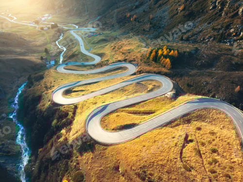 Preview: Aerial view of winding mountain road, river in alpine valley