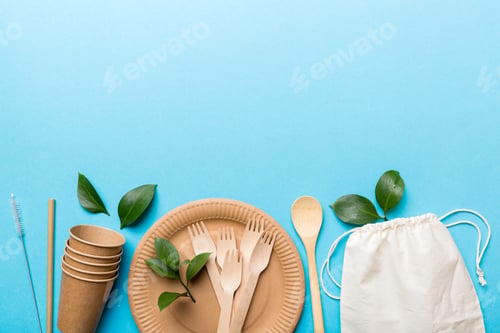 Preview: set of empty reusable disposable eco-friendly plates, cups, utensils on light