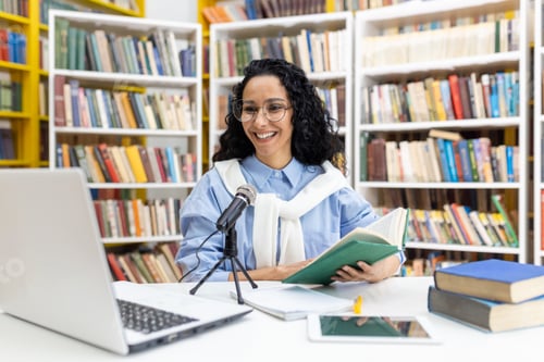 Preview: Happy librarian hosting a podcast in a colorful library