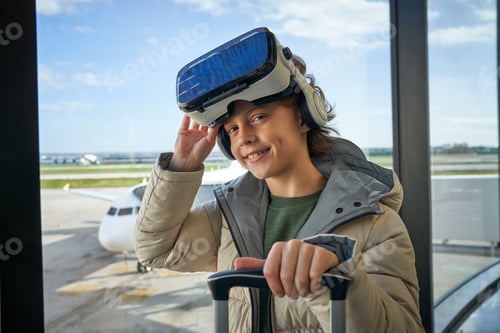 Preview: Content child adjusting VR headset and smiling at camera in airp