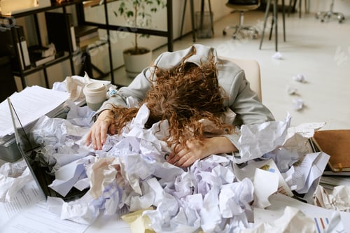 Preview: Young Woman Overwhelmed by Work Stress in Modern Office Setting