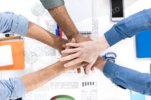 Preview: Close-up partial view of businessmen stacking hands while working on project together, business