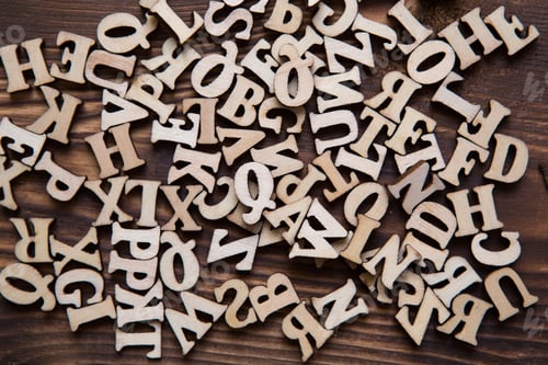 Preview: Letters of the English alphabet on a dark wooden background