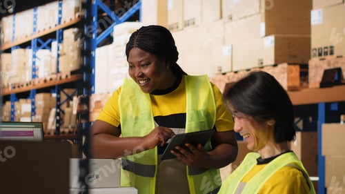 Preview: Satisfied coworkers sharing a high five after successful order processing