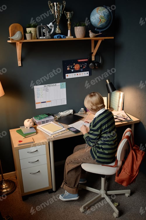 Preview: Boy Child Studying Science at Desk Demonstrating Academic Prodigy