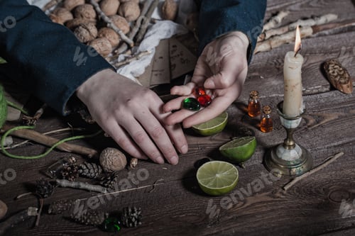 Preview: Hands Witch, Close-Up, Cooking Potion From A Variety Of Ingredients, Spread On A Wooden Table.
