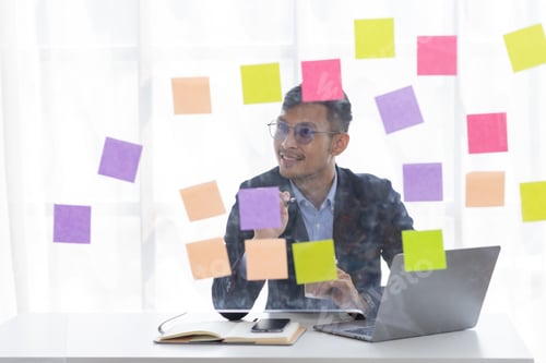 Preview: Concentrated adult business asian man, organizing his busy work week in the office. documents money