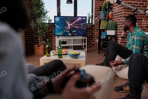 Preview: Men and women using tv console and joystick to play video games