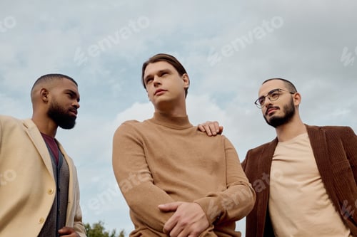 Preview: Stylish male models showcasing autumn fashion in a serene natural setting