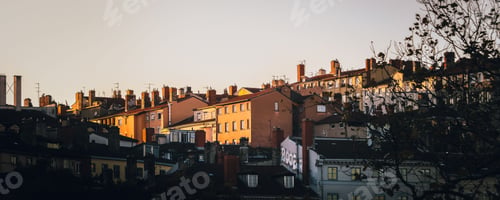Preview: Buildings illuminated by golden light at sunset in La Croix-Rousse. Lyon, France.