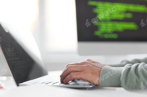 Preview: Man typing on laptop