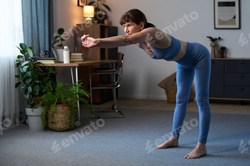 Preview: Senior Caucasian Woman Practicing Yoga Stretching Exercise Indoors