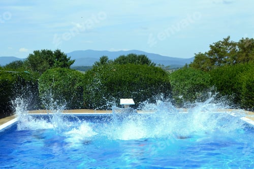 Preview: Several people jumping into a swimming pool and making a big splash.