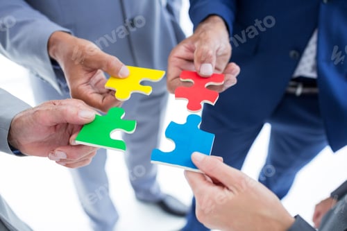 Preview: Business Colleagues Holding Piece Of Puzzle In The Office