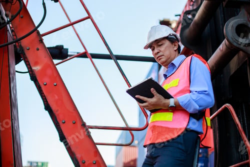 Preview: Asian foreman using tablet control loading containers box in cargo for import export,