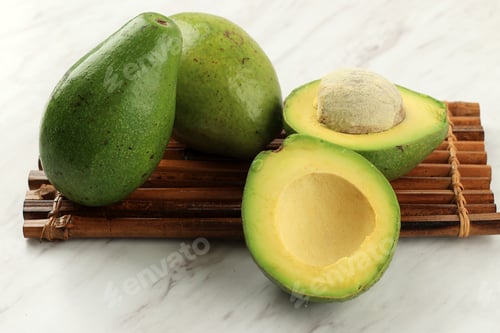 Preview: Ripe Avocado Half on White Marble Table