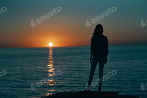 Preview: woman at sunset sea silhouette on the shore and beach sky