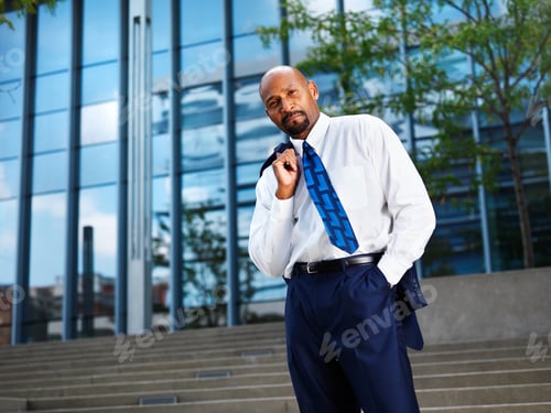 Preview: mature african businessman looking off in distance
