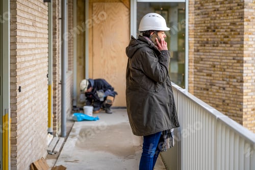 Preview: Female Construction manager walking around site on the phone