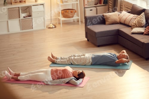 Preview: Elderly couple lying on floor after yoga practice