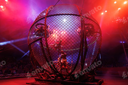 Preview: Dangerous show involving motorcyclists in circus. Stuntmen ride motorcycles in metal round cage.