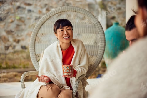 Preview: Smiling Woman Enjoying Conversation Holding Mug in Cozy Seasonal Environment