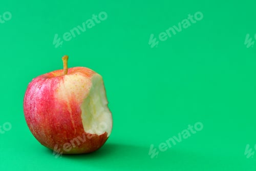 Preview: A red and yellow gala apple with a bite out of it on a green background.