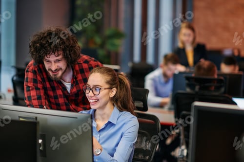 Preview: Business colleagues, a man and a woman, engage in discussing business strategies while attentively